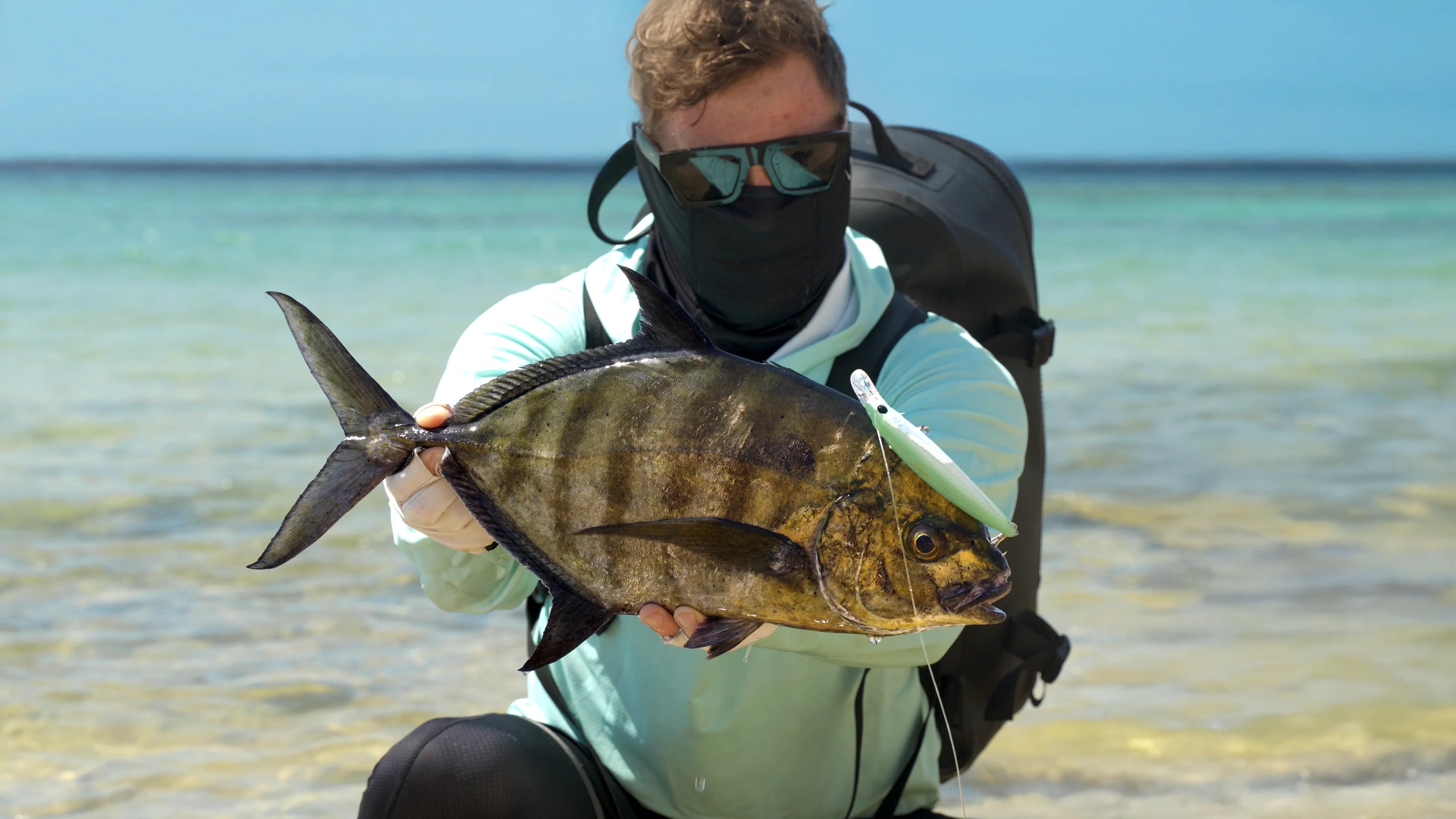 Close-up of a saltwater hard bait minnow hooked on a large GT fish, showing lure detail and saltwater fishing action tested by Cavy Fishing.