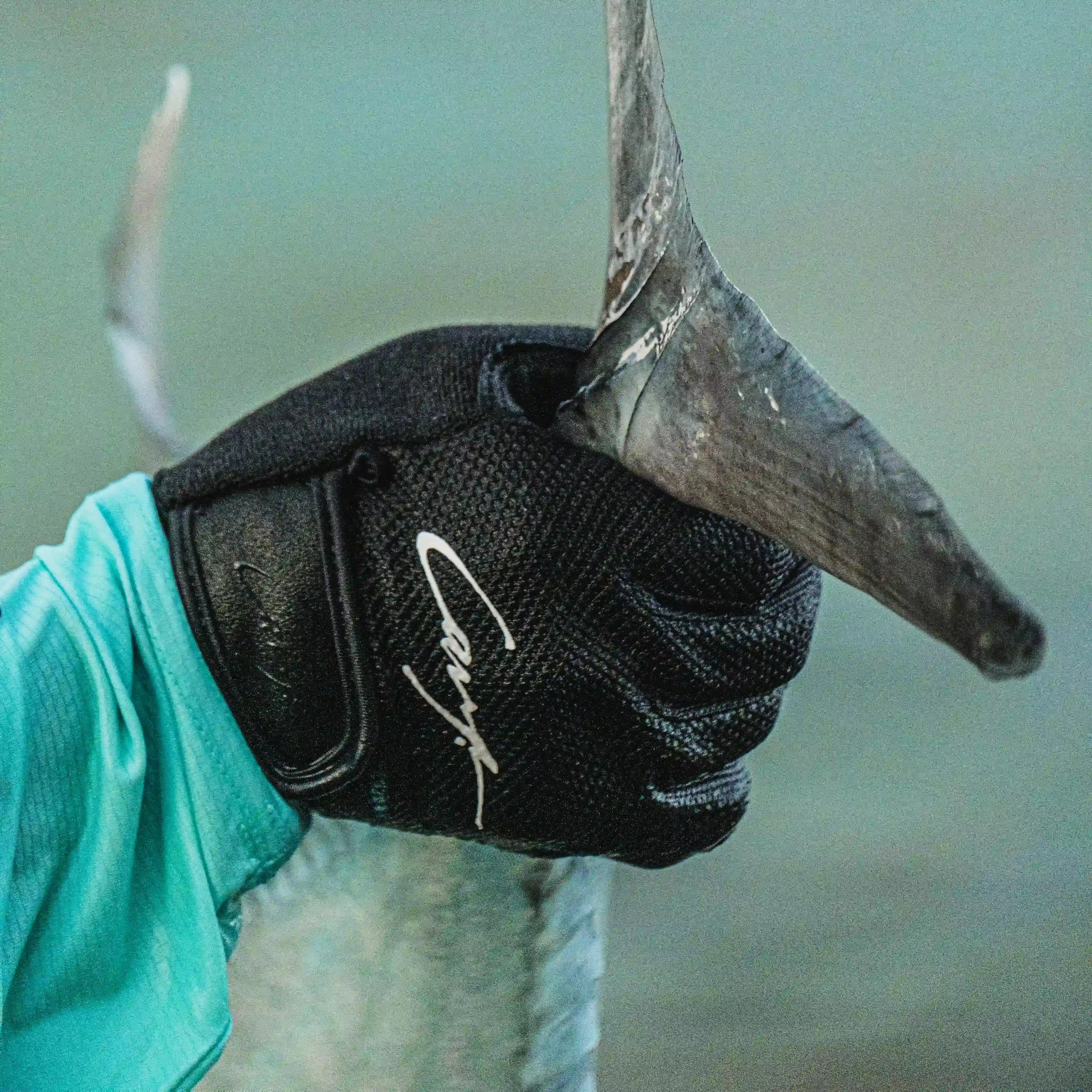 Angler wearing Cavy fishing gloves for braid cut protection while holding rod
