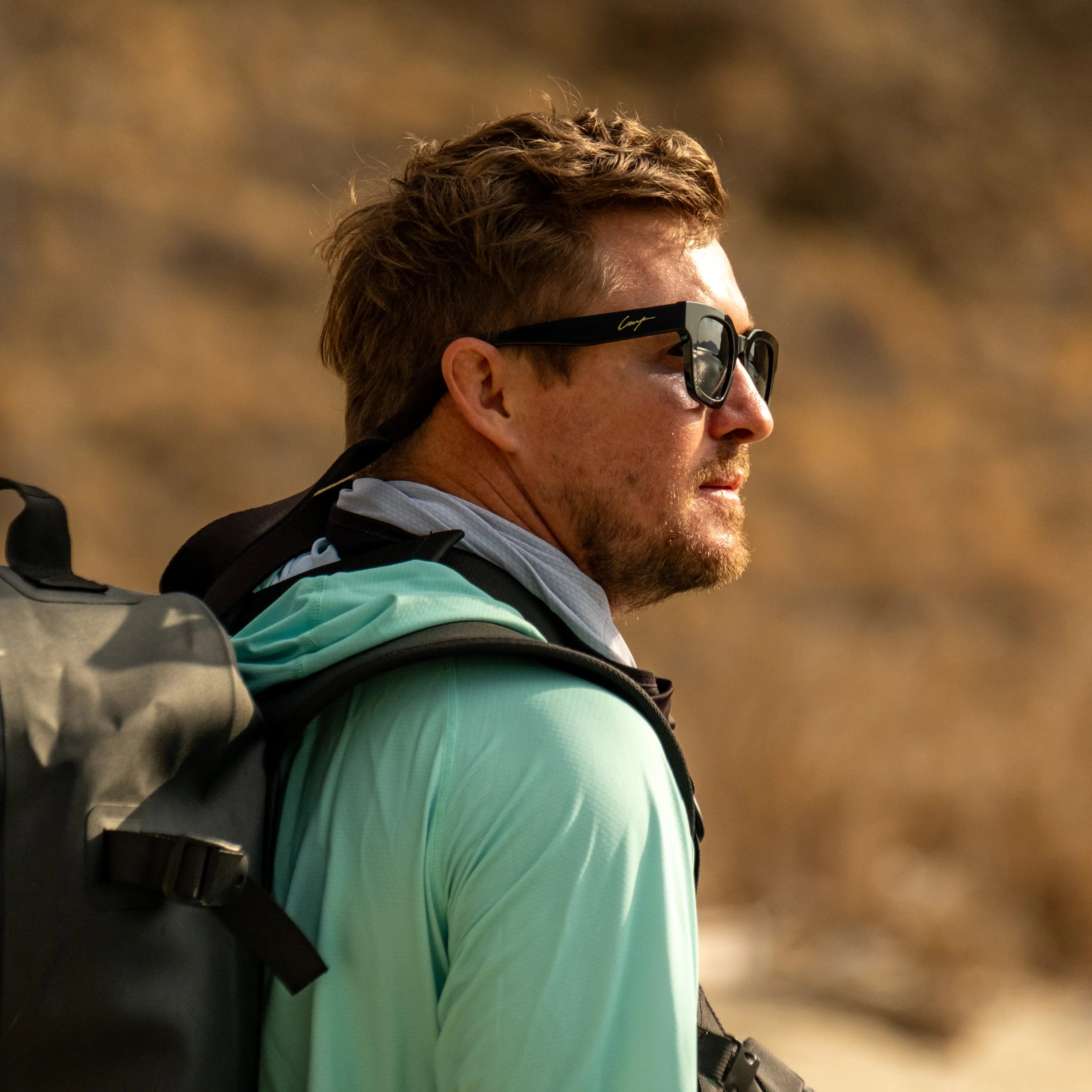Angler wearing polarised Cavy Fishing sunglasses while casting on the reef.