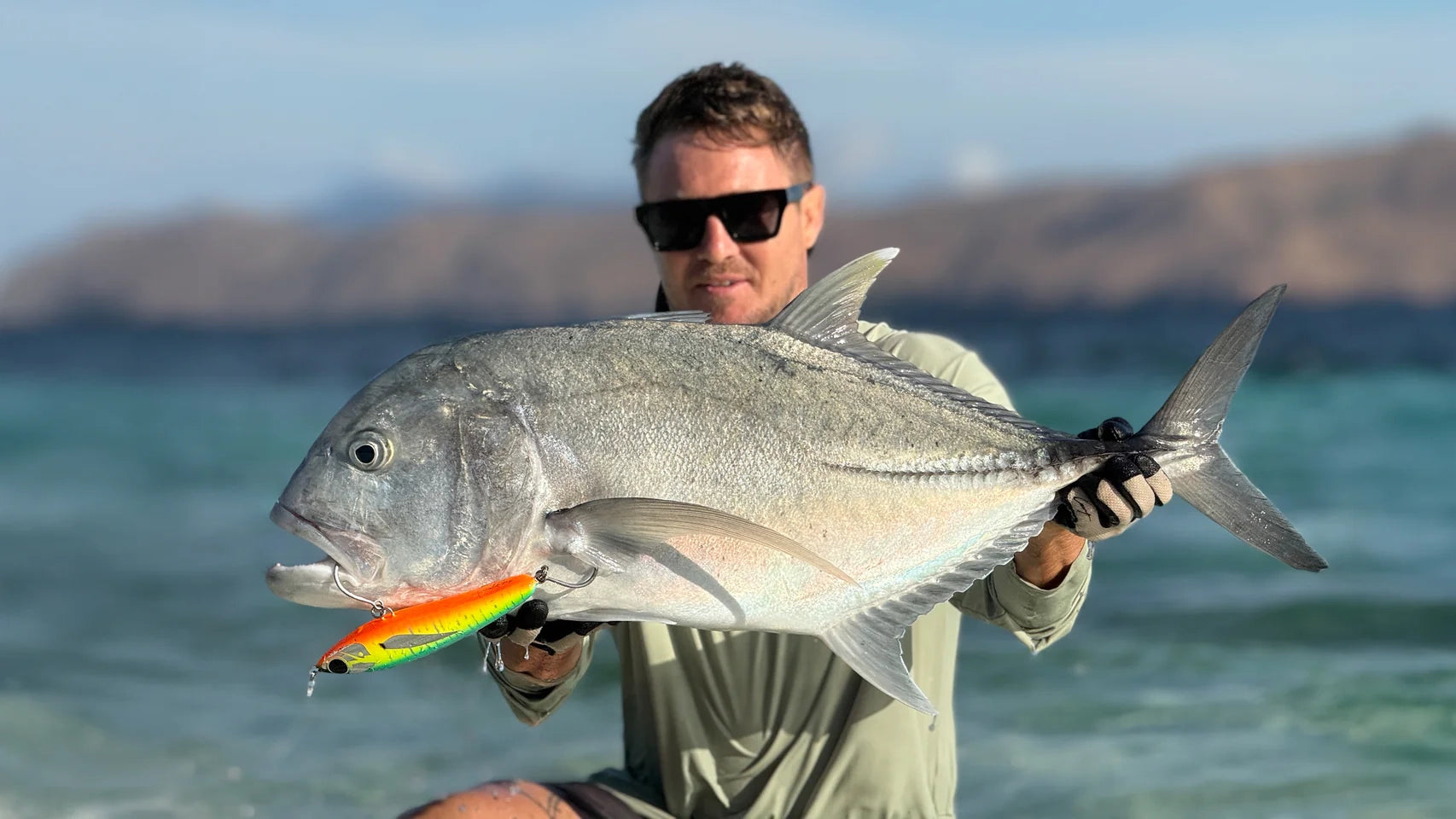 Adam Cavanagh holding giant trevally caught on Cavy Fishing handmade lure – brand video